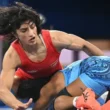 Vinesh Phogat preparing for a wrestling match with a determined look.