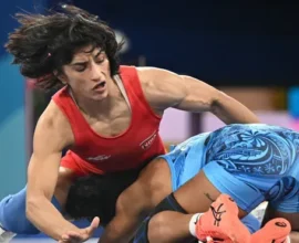 Vinesh Phogat preparing for a wrestling match with a determined look.