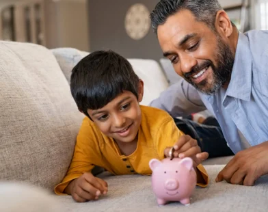 Indian_Father_With_Child_Piggy_Bank_Financial_Advice