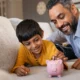 Indian_Father_With_Child_Piggy_Bank_Financial_Advice