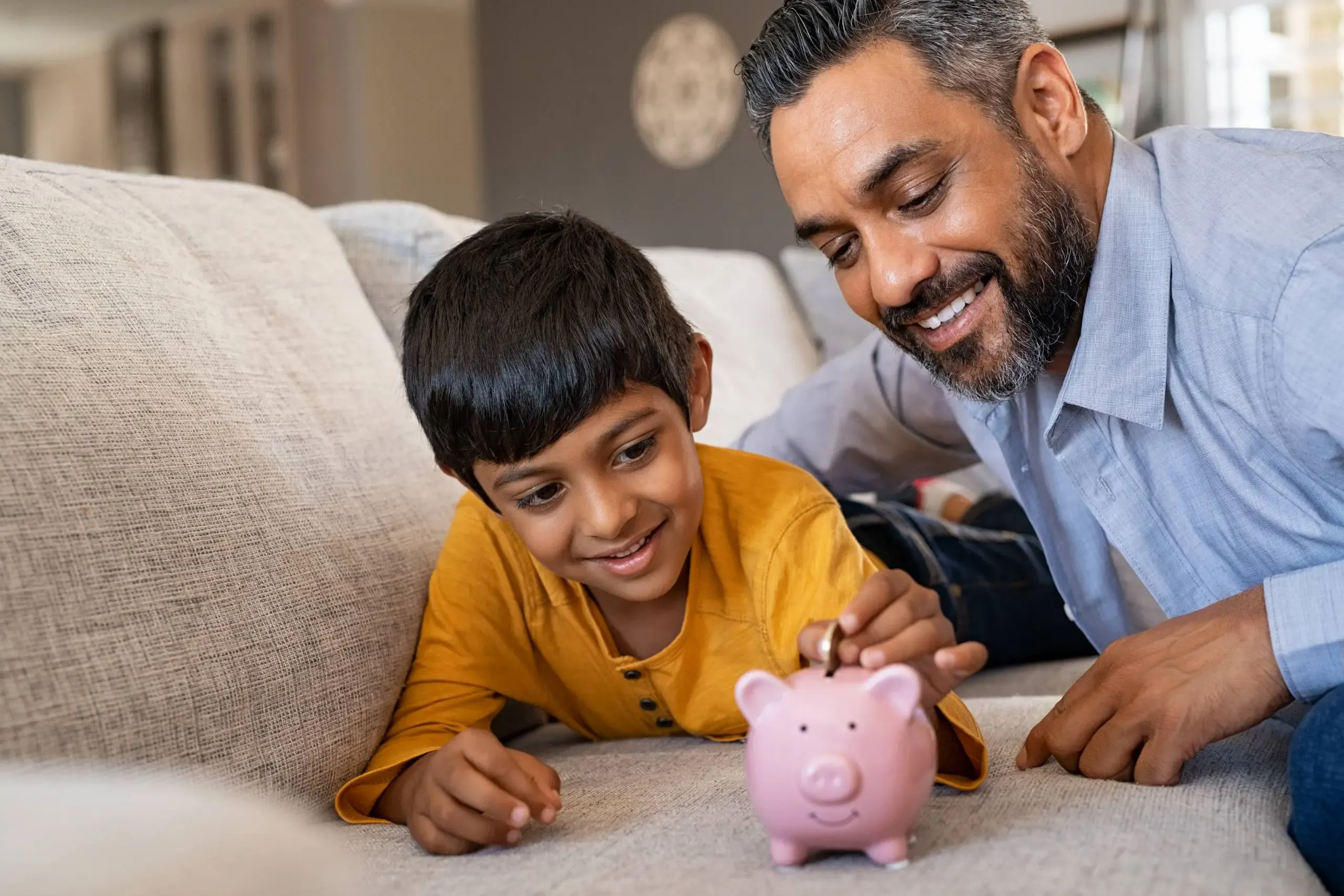 Indian_Father_With_Child_Piggy_Bank_Financial_Advice